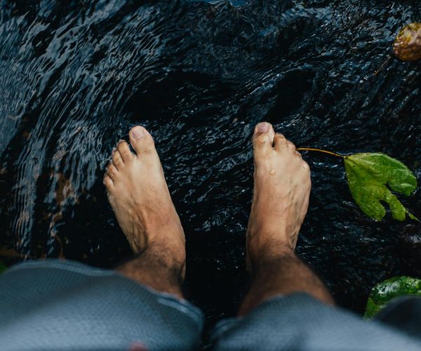 Person feeling refreshed and serene in a natural environment.